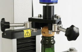 Gripping the cork securely for extraction force and torque measurement is essential